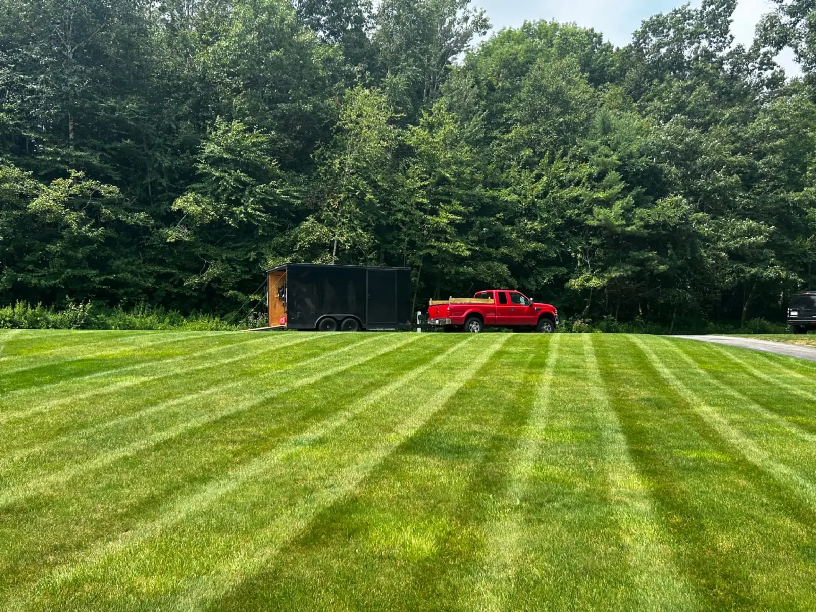 A big striped lawn, with the truck parked out back