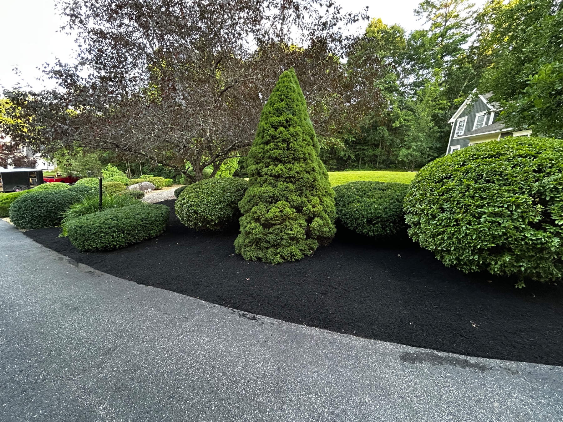 Professional mulch installation enhancing curb appeal in Charlton, MA.